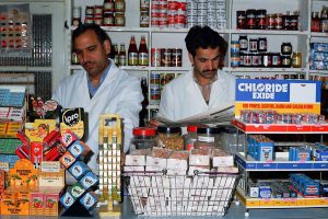 A photo by Chris Porsz taken in the 1980s of two shopkeepers in their.