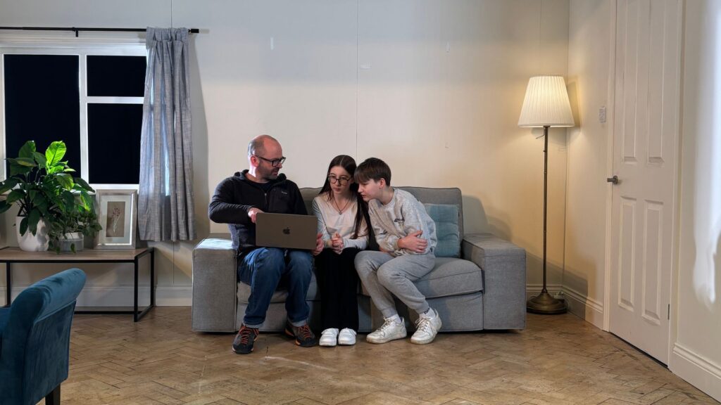 Mark Murphy on set with two community stars, Tomass and Kerija