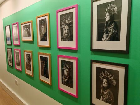 Twelve photographic portraits displayed artistically on the wall of unit 27. The black and white photos are portraits of the people who took part in Lore's crown making workshop.