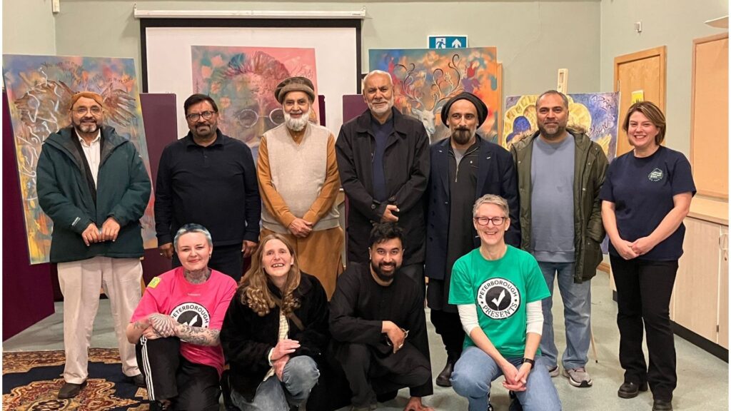 A group of 12 individuals involved in the Allama Iqbal project. 7 are stood and for are kneeling.